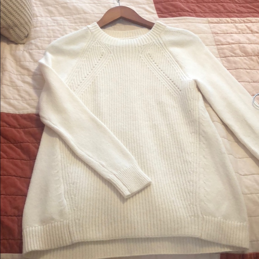 White/cream crew neck sweater.